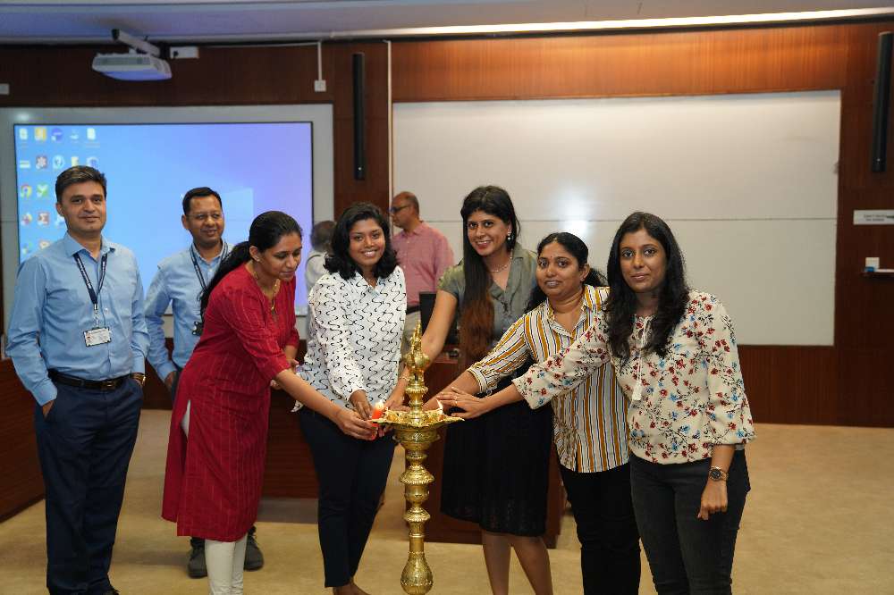Participants involved in a traditional lamp lighting ceremony during inauguration