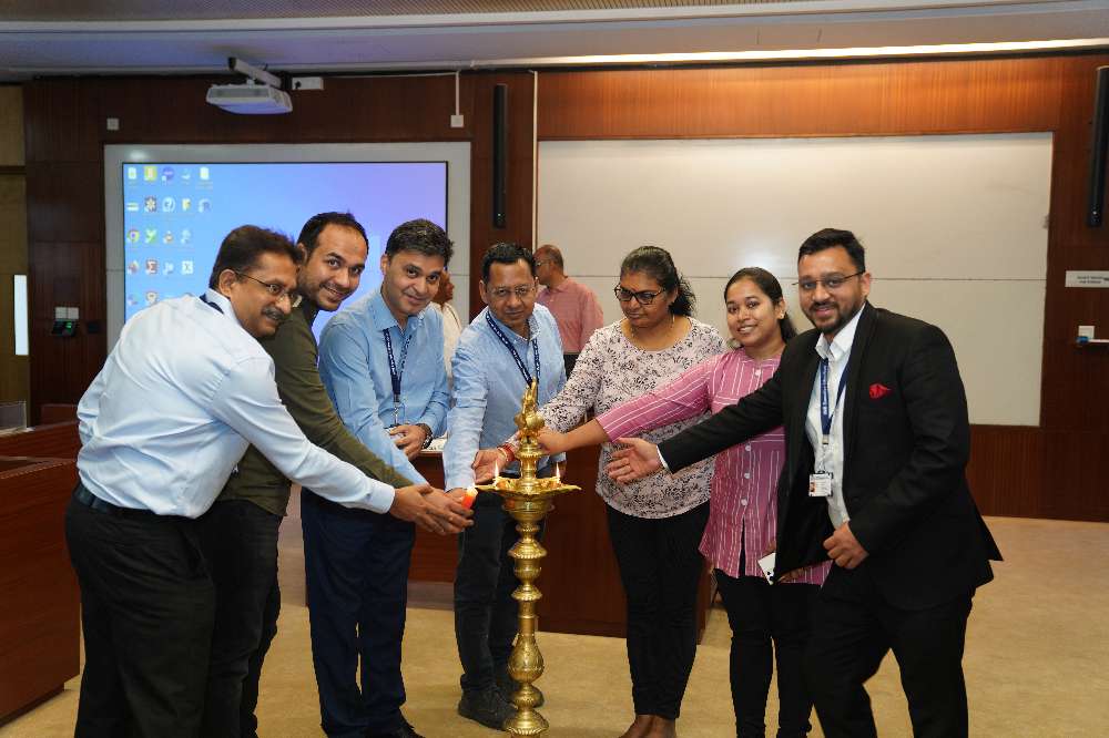 Participants involved in a traditional lamp lighting ceremony during inauguration