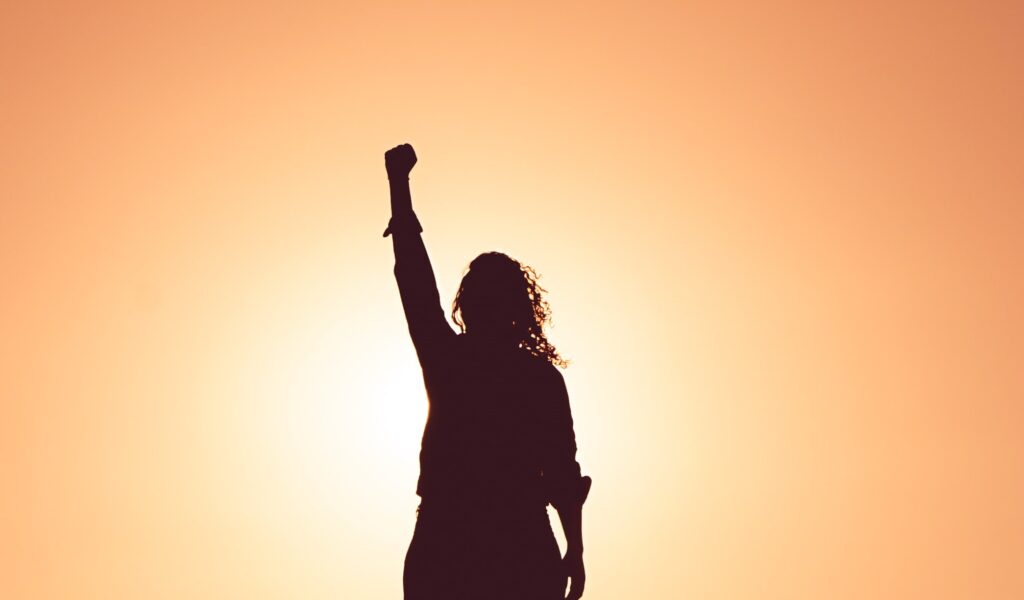 Image indicating success - image of a person with their fist held up high